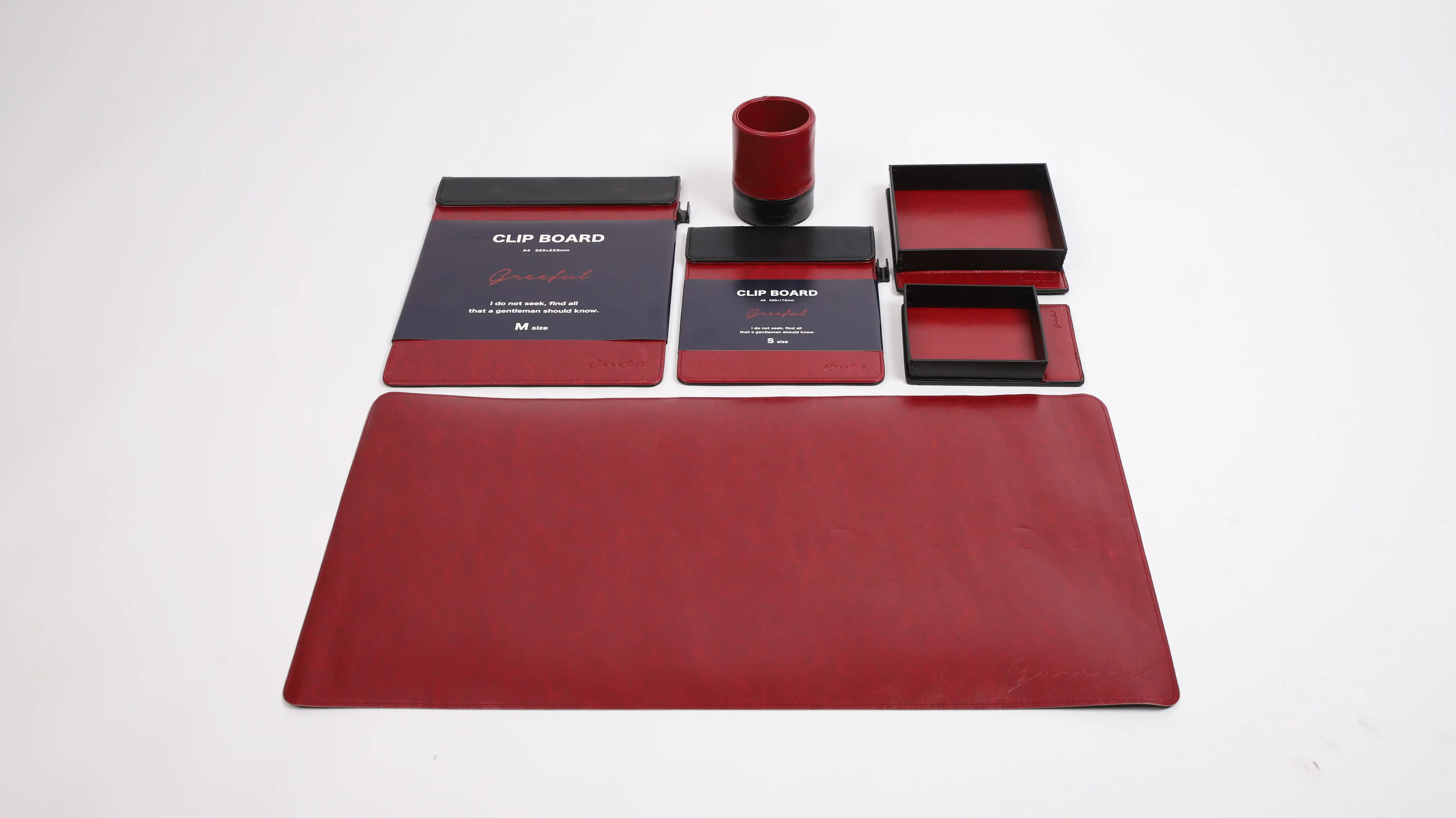 Red office supplies including a mouse pad, mouse, and stationery items on a white background